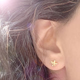 small flower earring stud on an ear