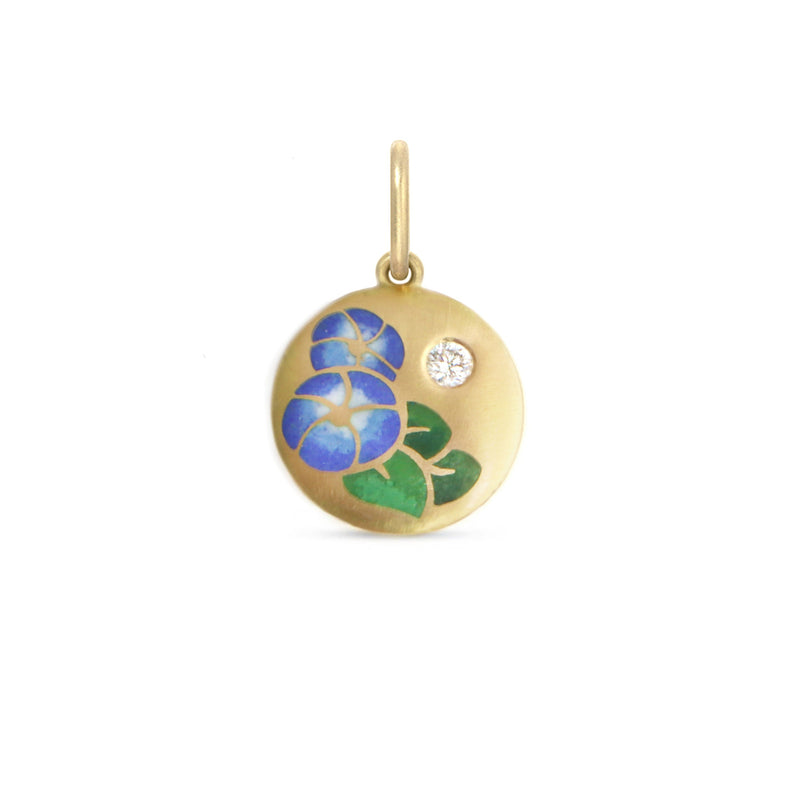 Gold pendant with painted floral design on a white background