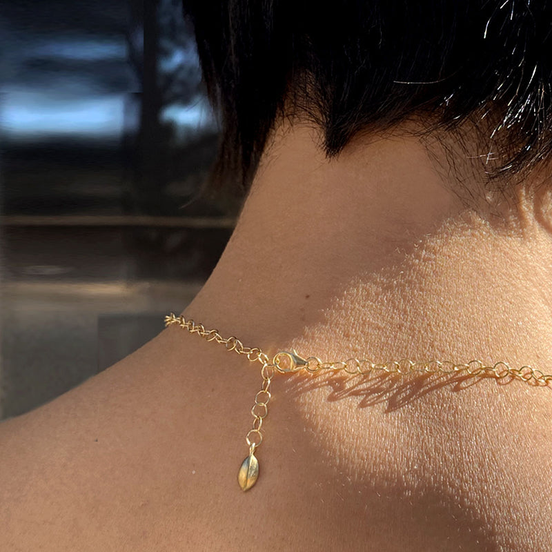 Gold Necklace with clasp and leaf tag in back of neck