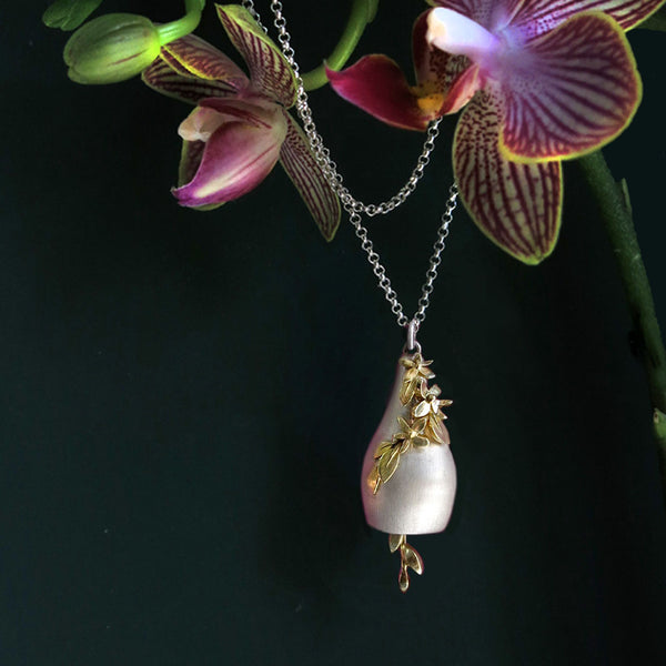 Silver and gold bell pendant with orchid
