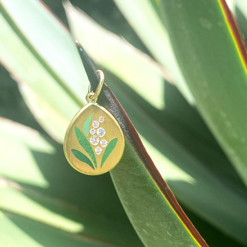 lily of the valley pendant hanging on a plant